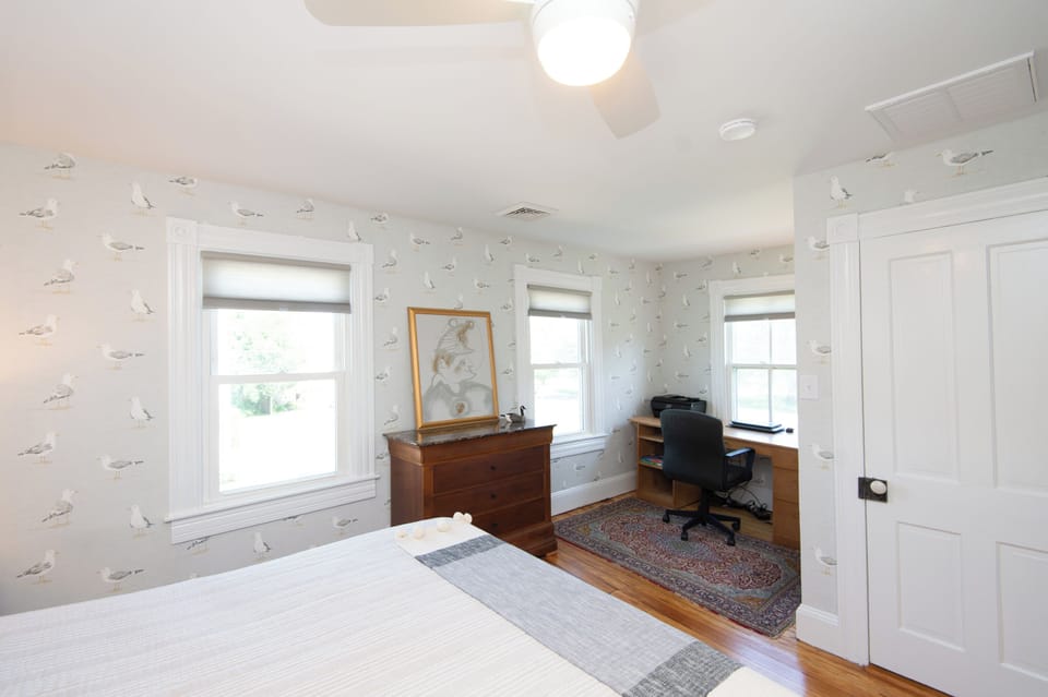 Front bedroom with views of Long Wharf Park including desk for remote work.