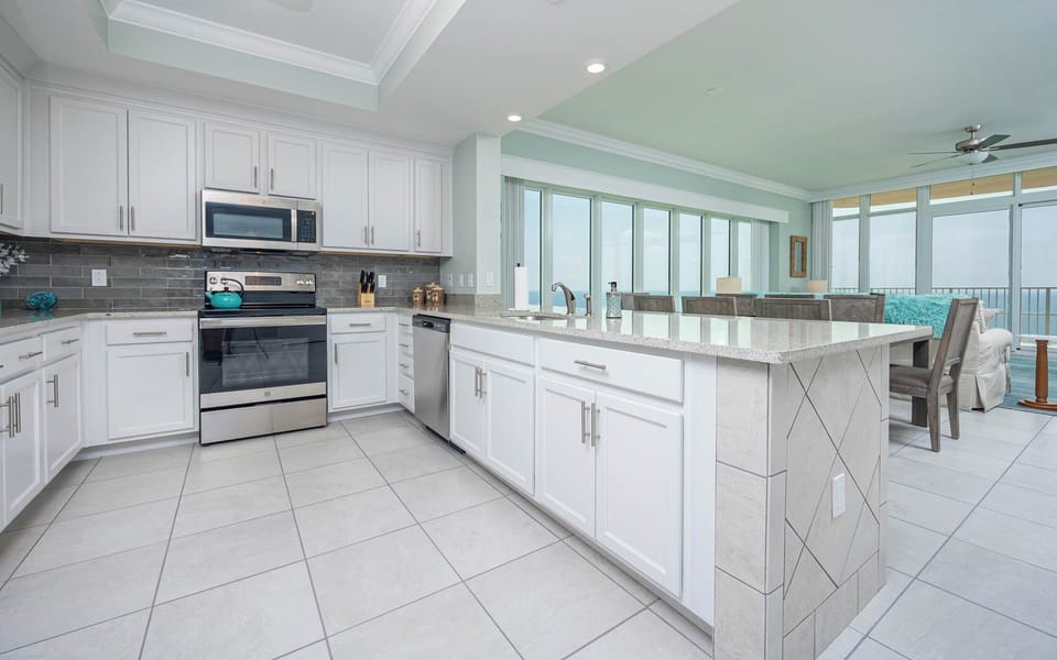 Prepare meals in this kitchen with elegant cabinetry, stainless appliances, and spacious countertops