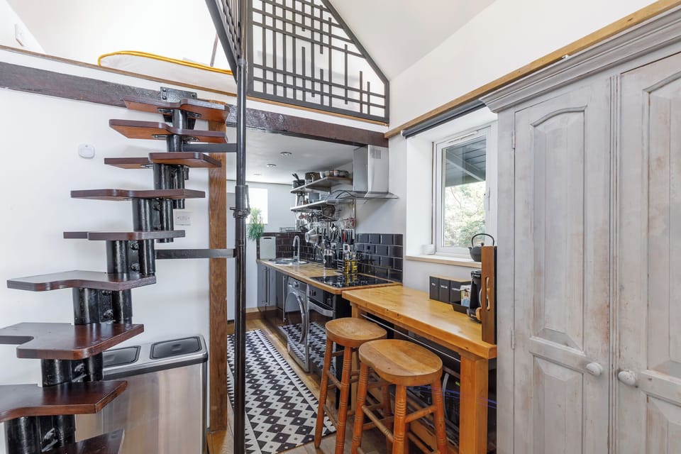 Stair case to mezzanine area and kitchen 