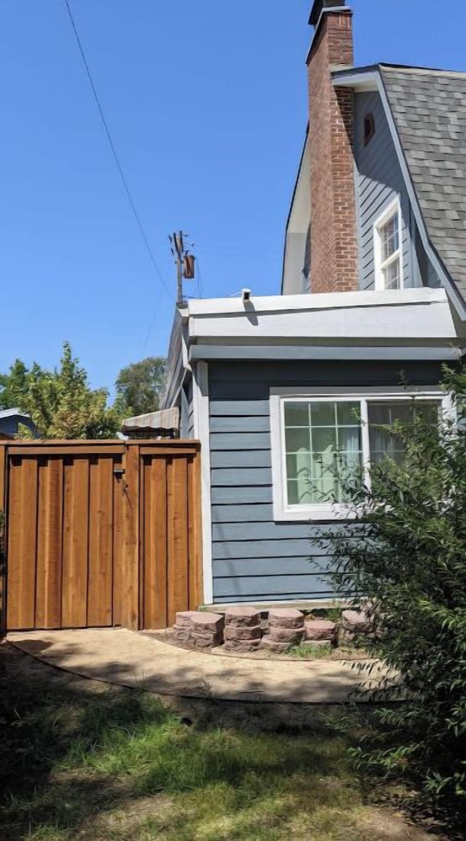 Front of the house with entry gate to private patio.