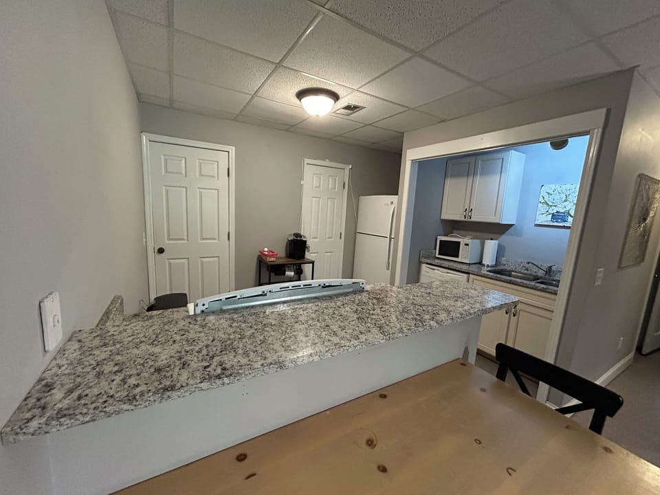 Dining table, sink, microwave, pantry