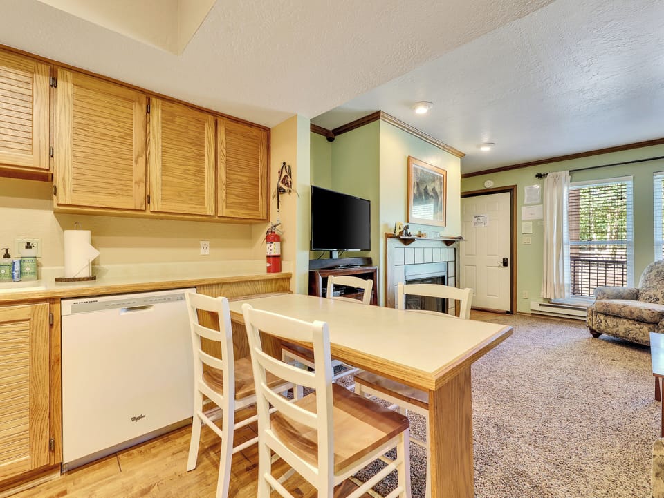 View of Dining Area, seating for 4, dishwasher and upper kitchen cabinets
