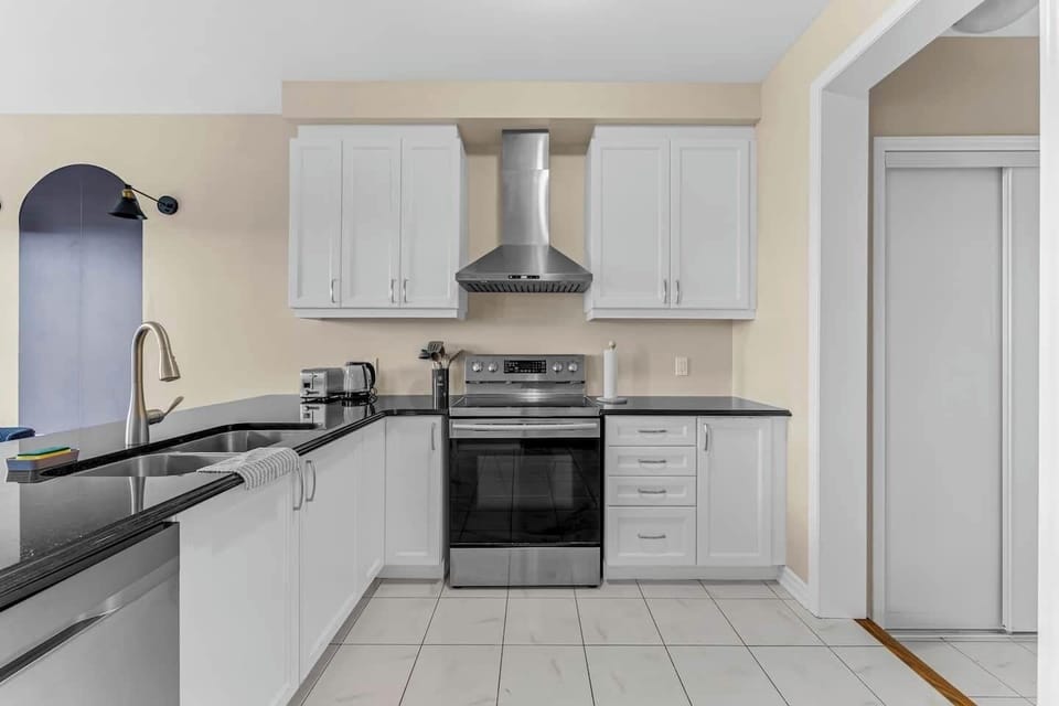 Stylish kitchen with modern appliances, sleek counters, and plenty of cabinet space!
