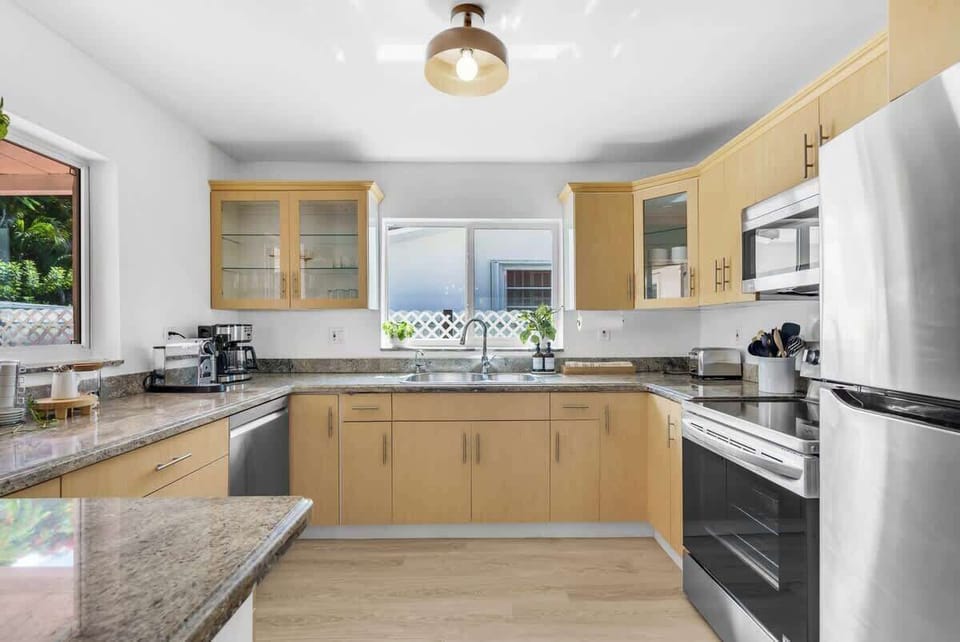 This fully equipped kitchen features sleek granite countertops, stainless steel appliances, and a modern dishwasher. Everything you need for a perfect self-catering vacation."