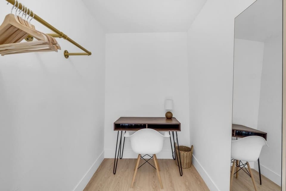 "Work from home in style! 💻 Our dedicated workspace features a minimalist desk, ergonomic chair, and a full-length mirror. High-speed Wi-Fi makes this the perfect short-term rental for remote professionals. ✨"