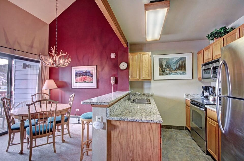 Cook and entertain in the charming kitchen, equipped with modern amenities, a breakfast bar, and ample counter space for meal preparation.