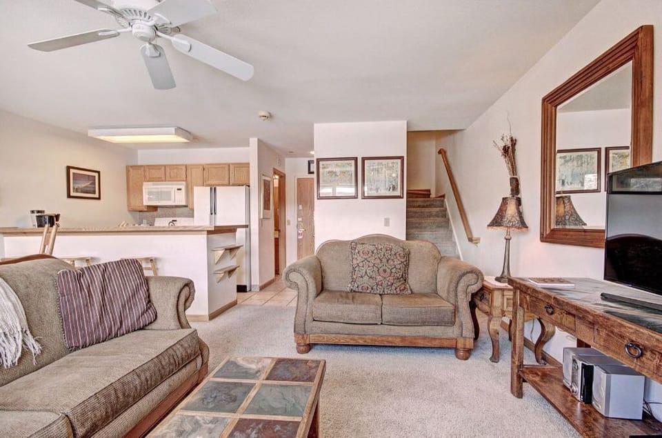 Relax in the spacious family room featuring cozy sofas, a coffee table, and ample natural light.