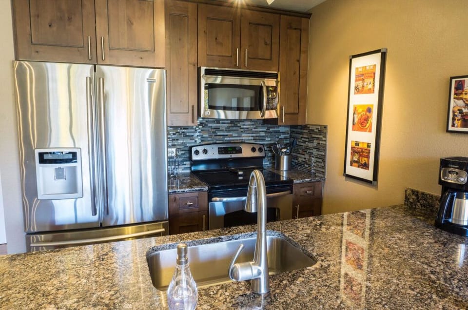 Cook in style in the modern kitchen equipped with stainless steel appliances, granite countertops, and ample cabinet space.