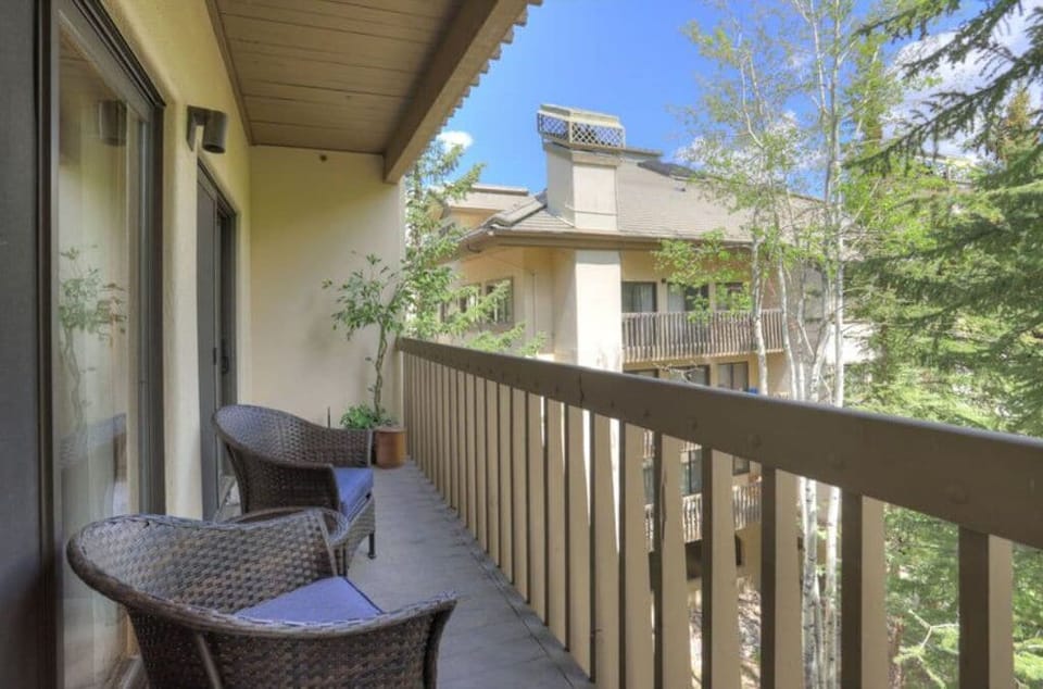 Relax on the private balcony, offering serene views of the surrounding nature and a peaceful outdoor seating area.