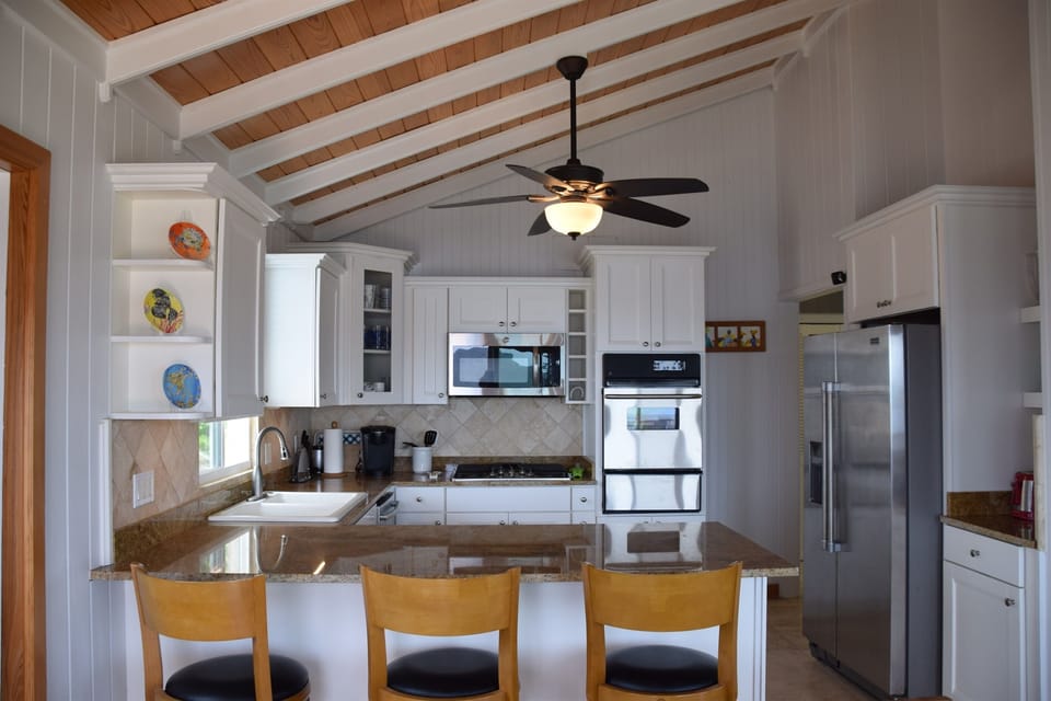 Upstairs kitchen with island that seats 3 and table that seats 4
