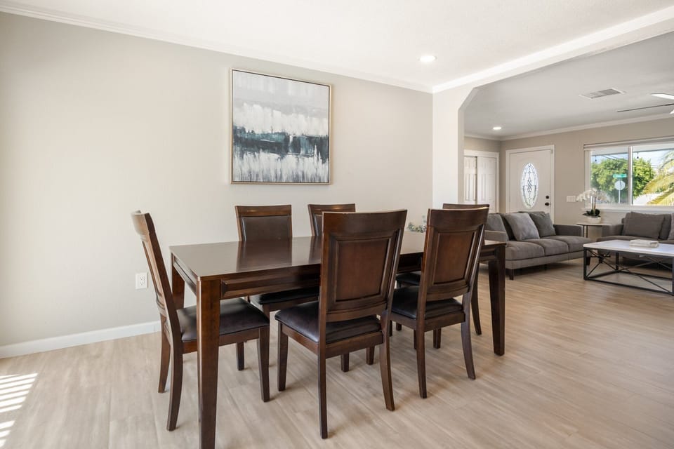 A proper dining table with seating for everyone to sit down for meals together.