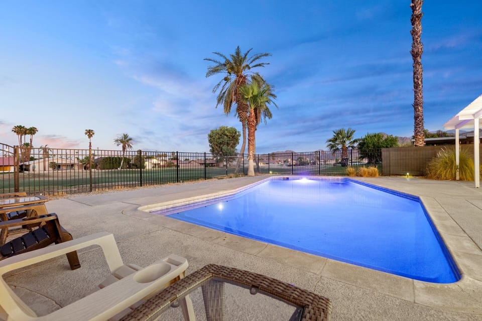 The pool glows blue at twilight with those stunning golf course views all around you.