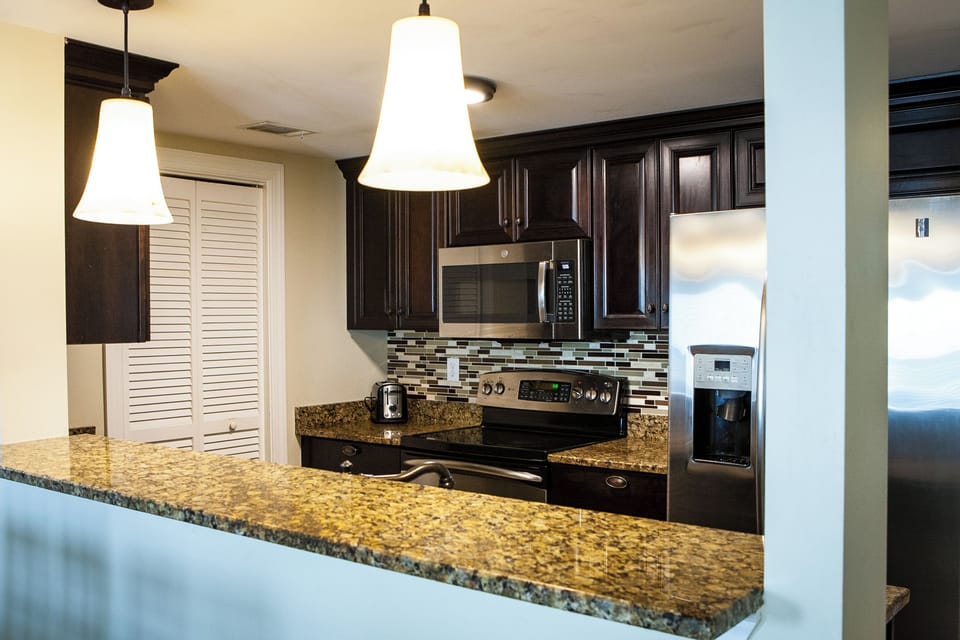 Fully equipped kitchen with stainless appliance and large pantry