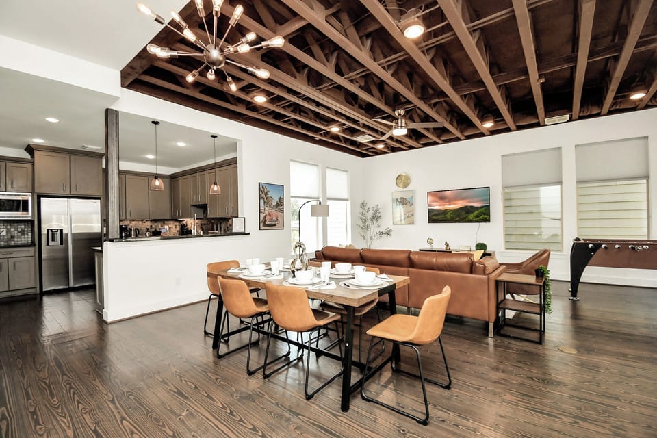 A stylishly decorated living room and an open dining area.