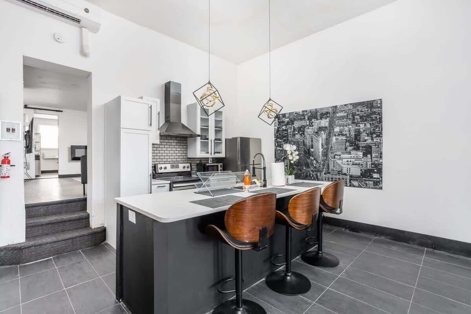 Pristine kitchen with bar seating and artistic accents