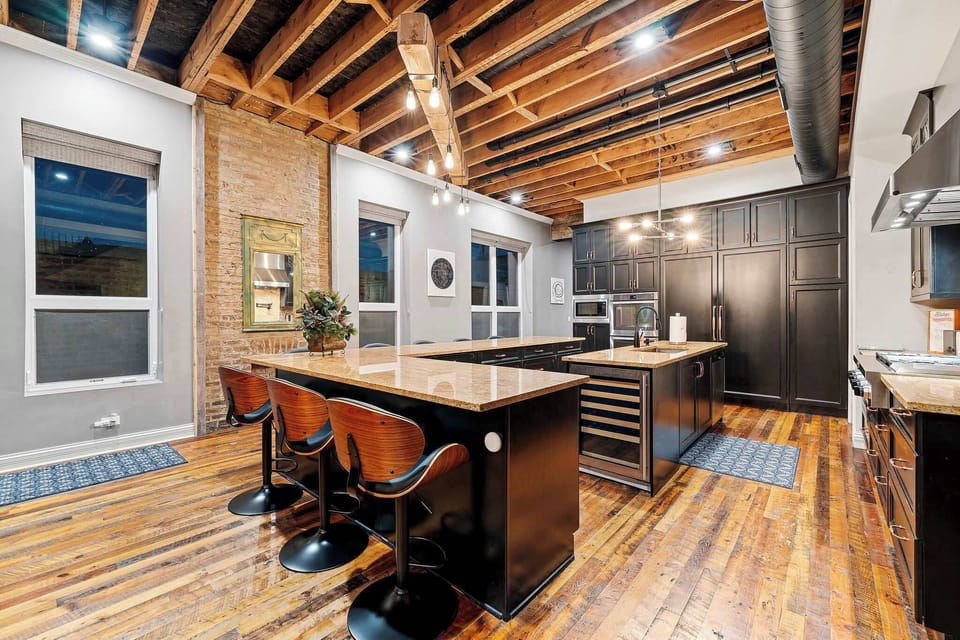Spacious kitchen setup w/ island seating, perfect for casual meals and conversation.