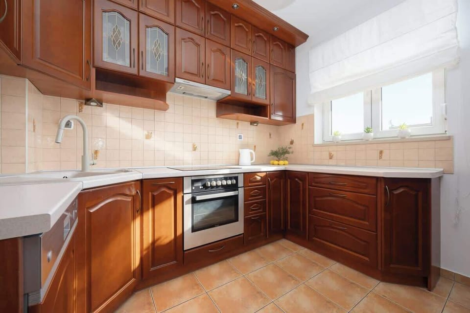 Kitchenette features an induction cooktop, fridge with freezer, oven, dishwasher, electric kettle and microwave.