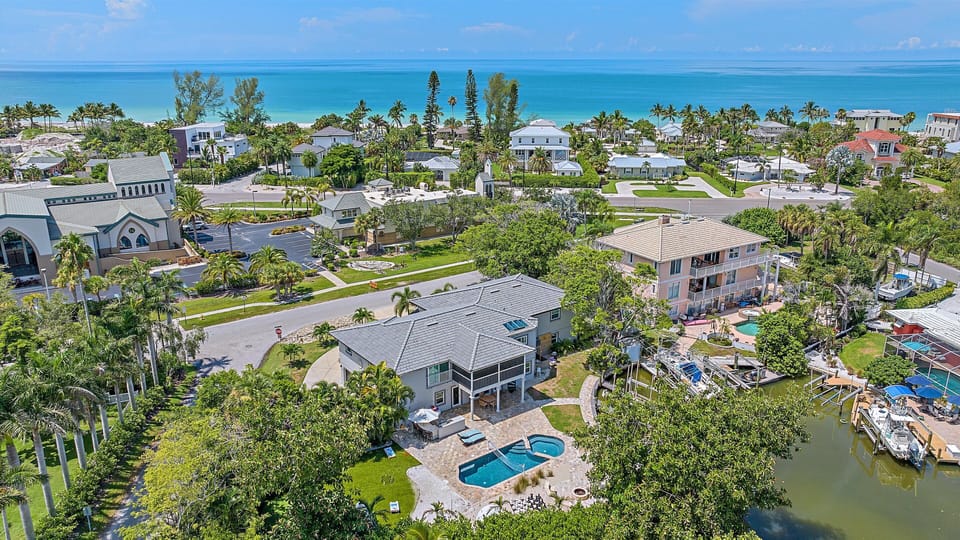 This stunning Sarasota vacation home offers the best of both worlds with a sparkling private pool, convenient canal access, and breathtaking proximity to the pristine Siesta Key beaches.