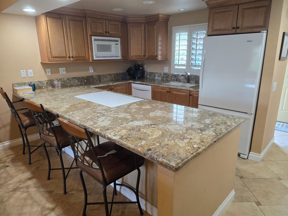 Fully stocked kitchen and refrigerator with ice maker.