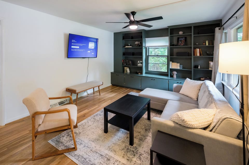 The spacious living room has plenty of seating and a Roku smart TV. 