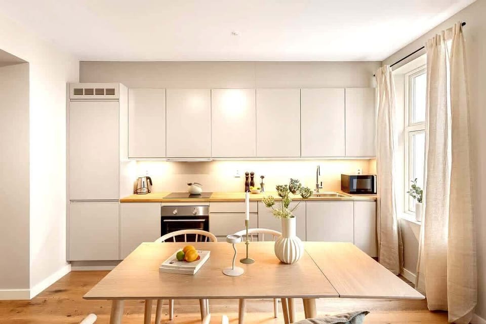 Fully equipped with sleek cabinetry and island seating.