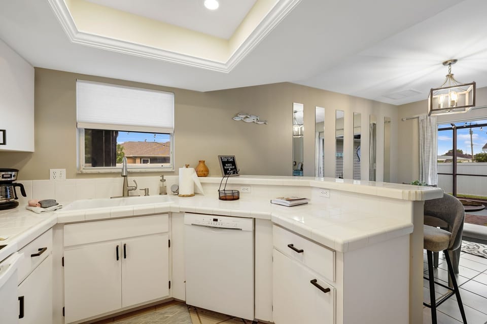 Open view from the kitchen with the main dining area just to the right. The window is a direct view out to the lanai and pool.