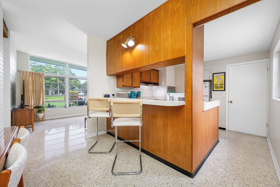 Open and airy mid-century kitchen and dining area with retro terrazzo floors
