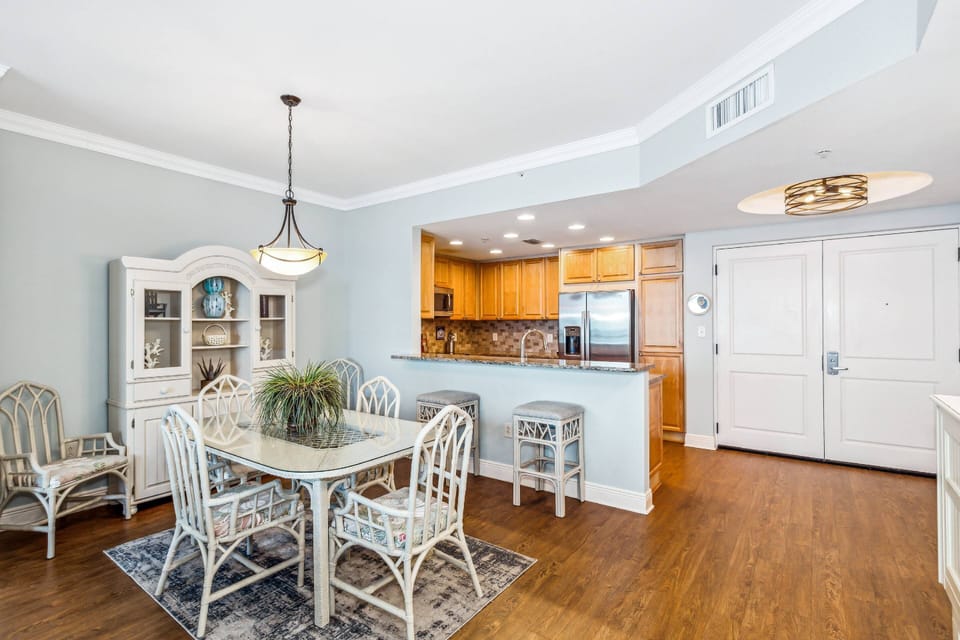 Dining area with a table for four and bar stools