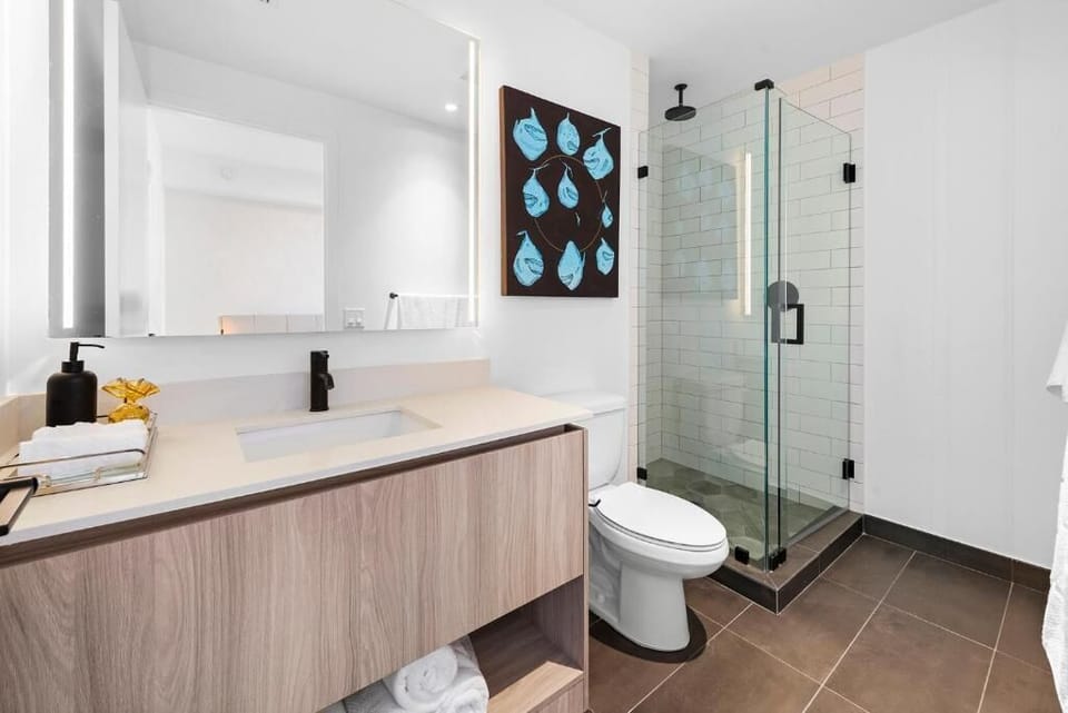 Step into a glass shower for a spa-like rinse.