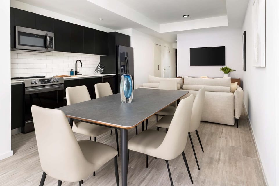 Gather for meals at the stylish table beside the kitchen.