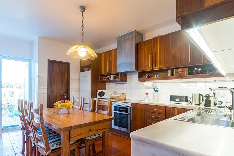 Spacious kitchen and dining area with wooden cabinetry — Villa Atlantic Blue, holiday villa in Mafra