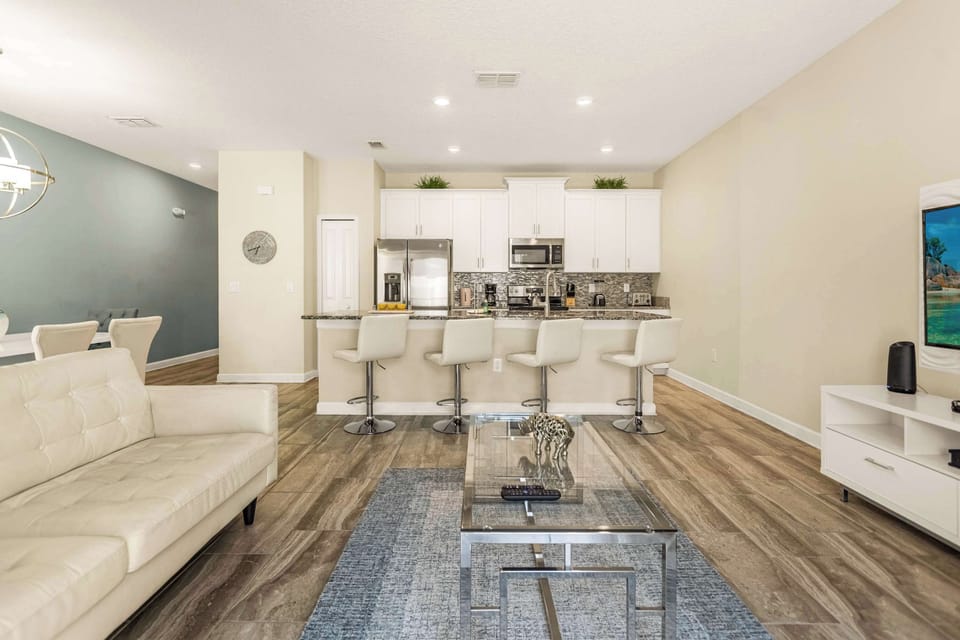 Spacious open-plan living area with modern kitchen and cozy seating, perfect for relaxing after a day of exploring.