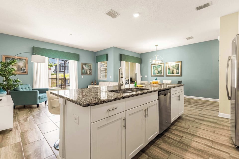 Bright and modern kitchen with granite countertops and open layout, perfect for family gatherings and culinary adventures.