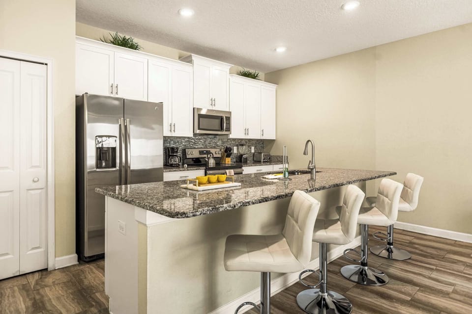 Sleek and modern kitchen with granite countertops and stainless steel appliances, perfect for culinary adventures.