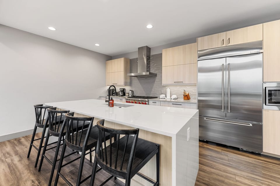 Full kitchen with stainless steel appliances and breakfast bar with seating for 4.