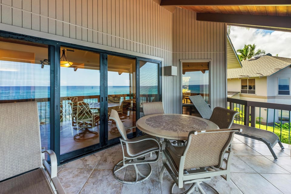 Step onto your private lanai and take in breathtaking ocean views from your own table for sunrise coffee or sunset cocktails. This serene outdoor retreat invites you to unwind in coastal comfort.