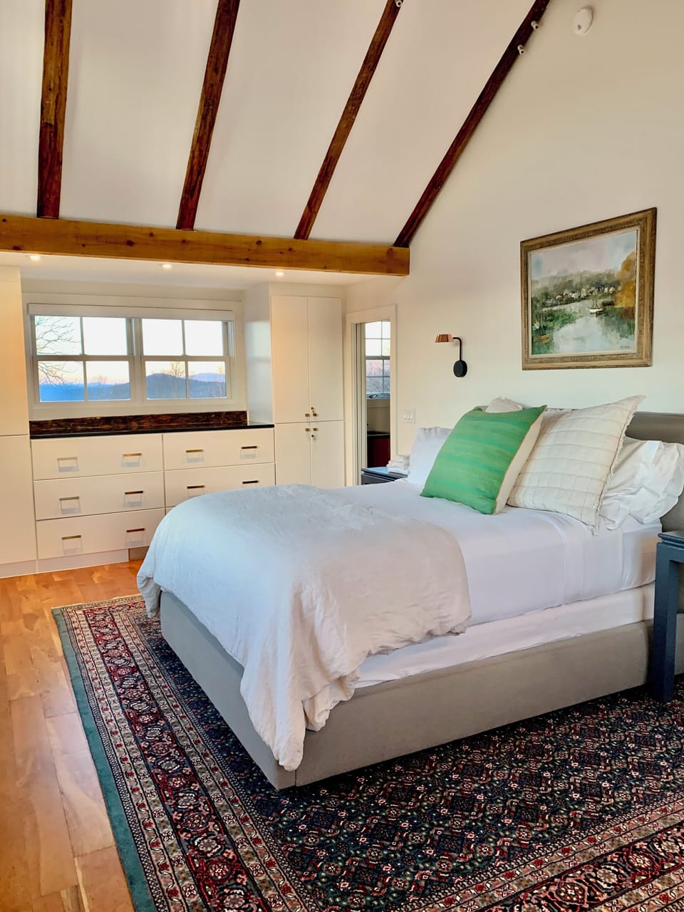 Plush Queen Beds & Linens with custom built-in cabinets.