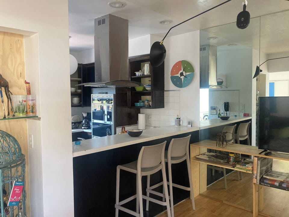 bar in media room that opens to kitchen