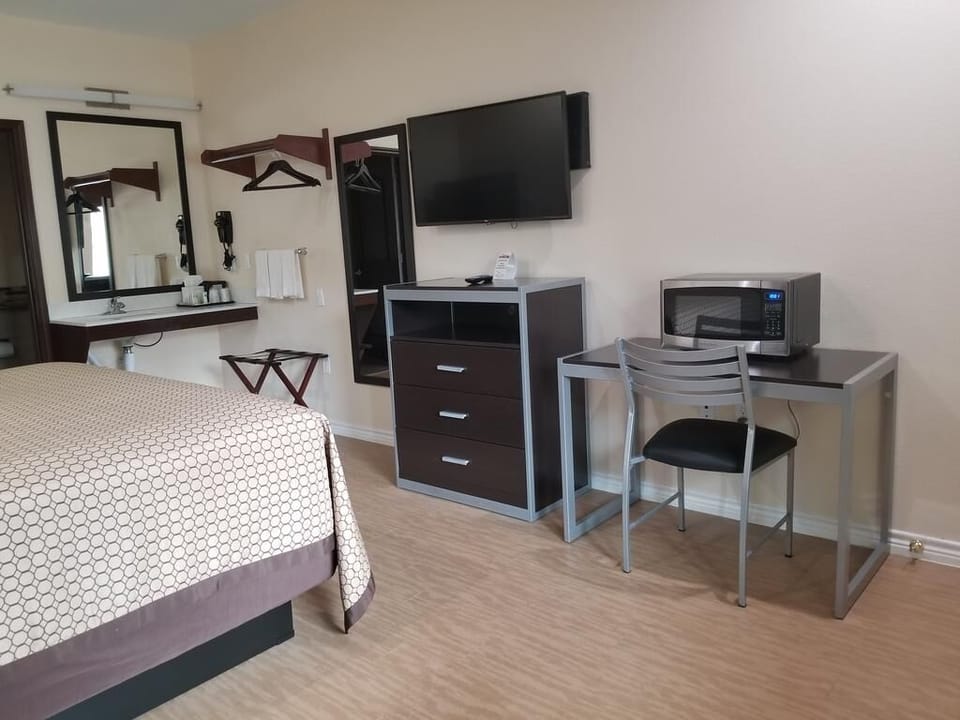 Unwind after adventure with TV, desk, and cozy bed.