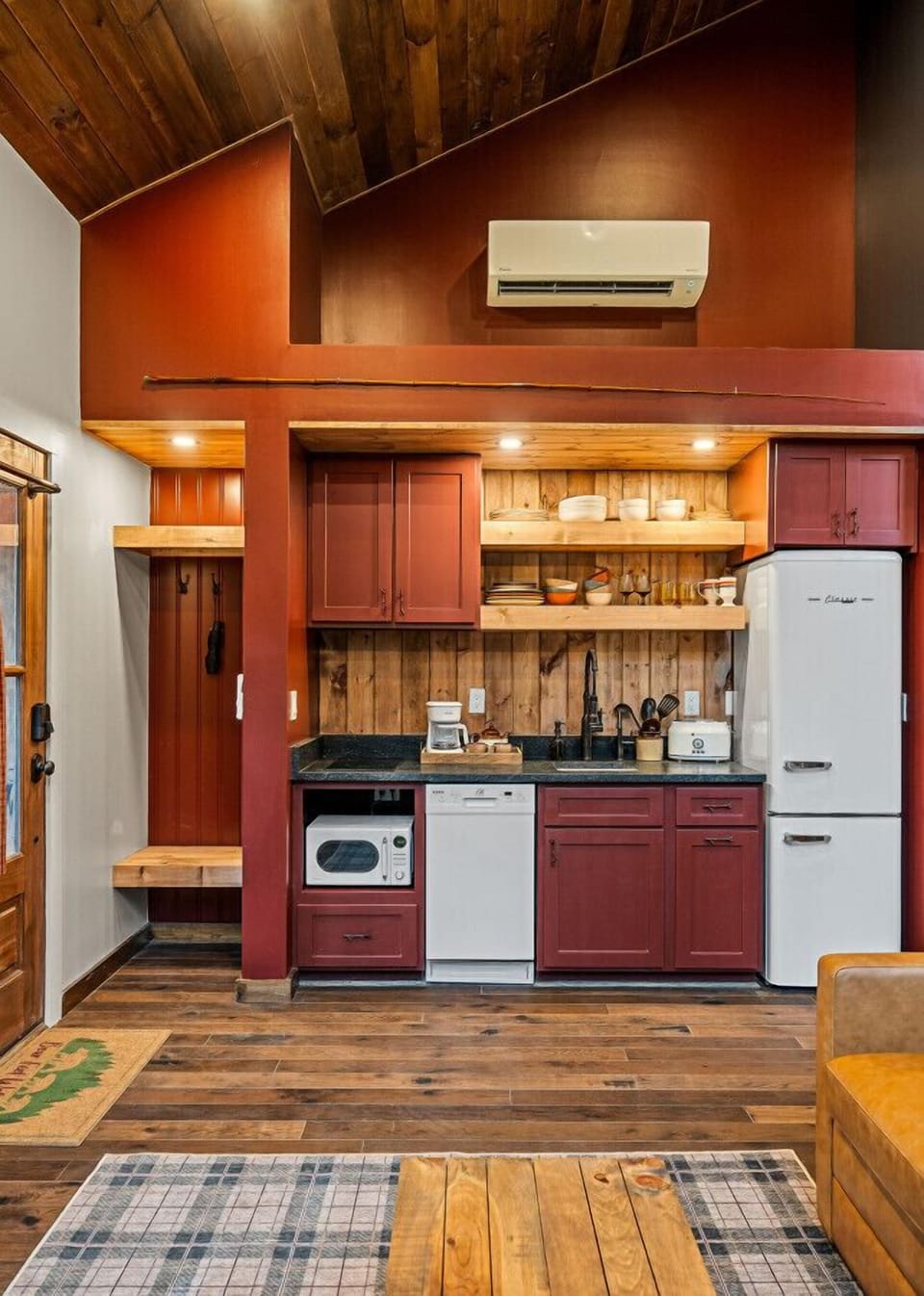 The kitchen features a two-burner electric cooktop, ice maker, microwave, toaster, blender, dishwasher, and refrigerator, along with a coffee maker that uses our custom Hideout coffee blend.