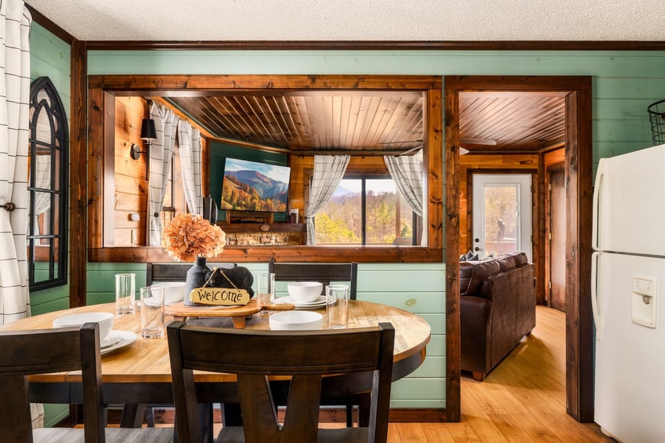 Gather at the dining table with views through the living room and beyond—meals with a backdrop
