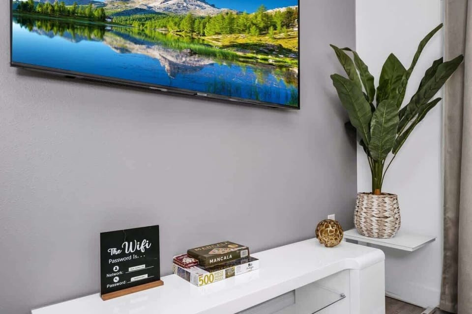 Relax in the spacious living room area, complete with cozy seating and a smart TV for your entertainment.