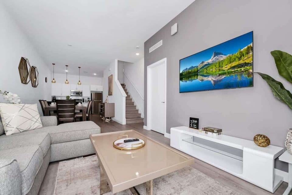 Relax in the spacious living room area, complete with cozy seating and a smart TV for your entertainment.