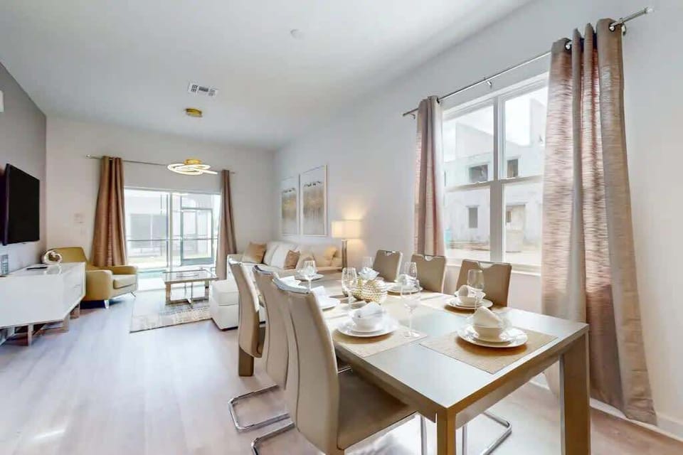 The dining area featured a rustic wooden table surrounded by comfortable chairs, perfect for enjoying meals with family and friends.