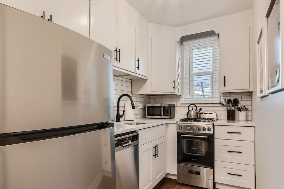 Newly updated kitchen is compact and functional, with a dishwasher and full sized fridge 