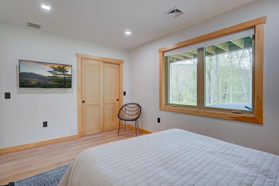 Bedroom features a 43 inch tv and closet storage.