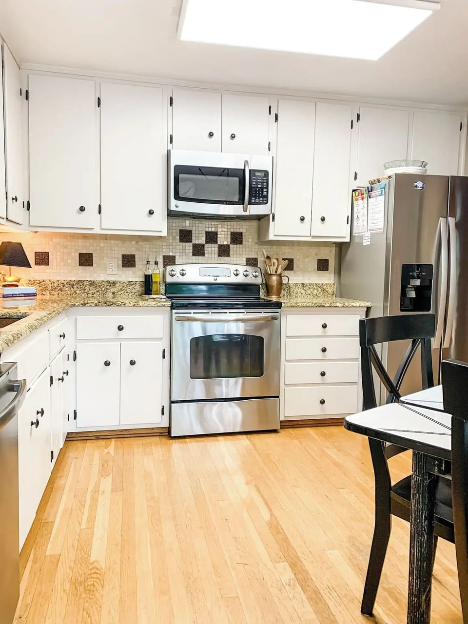 Fully stocked eat-in kitchen with stainless steel appliances