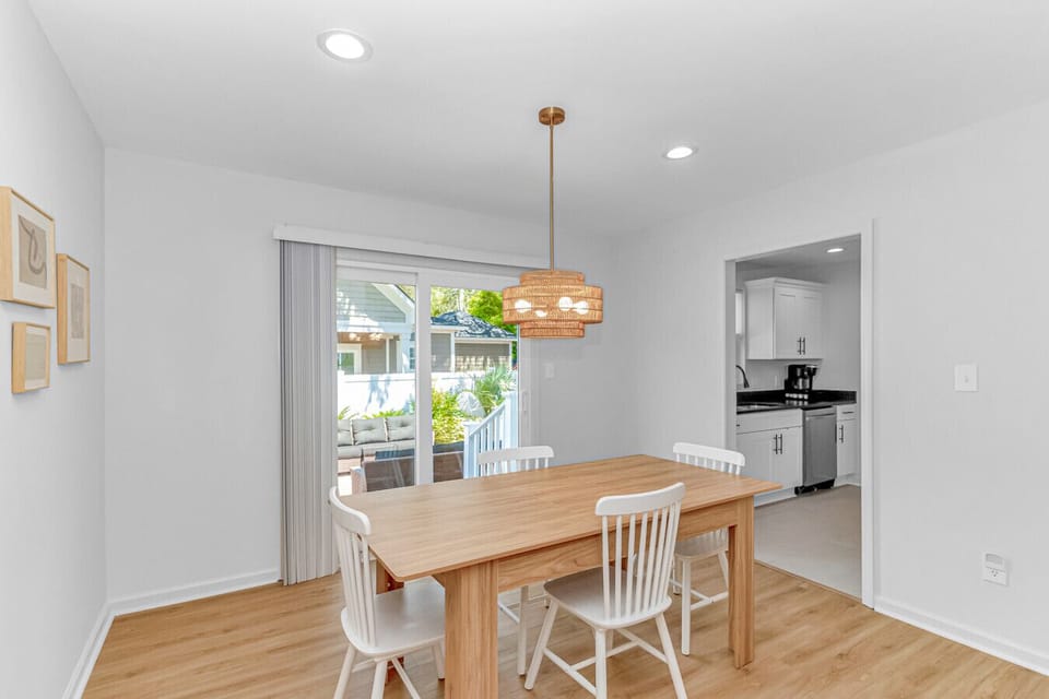Dining space with sliding doors to patio and open connection to kitchen ideal for family meals