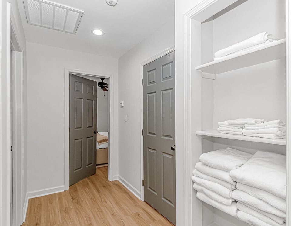 Hallway with easy bedroom access and fully stocked clean linens