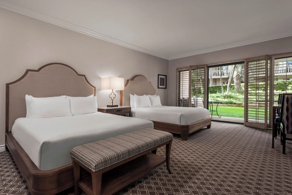Unwind in airy beds with peaceful garden views.